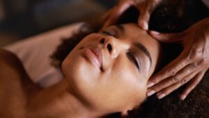 a woman getting a head massage at a spa.