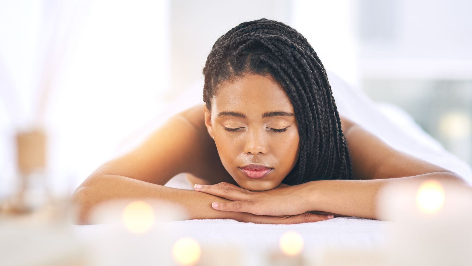 A woman laying down at a day spa ready for a massage.